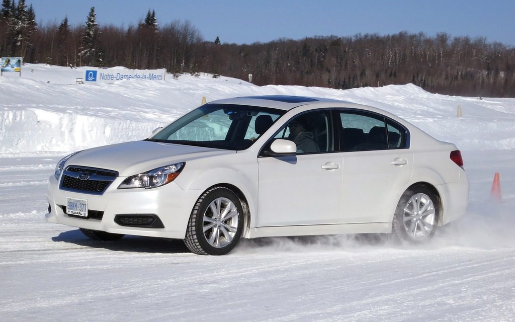 The 2013 Subaru Legacy driving in snow.