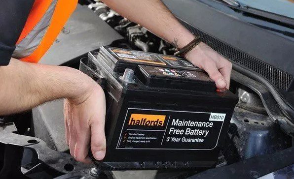 Inserting the new car battery