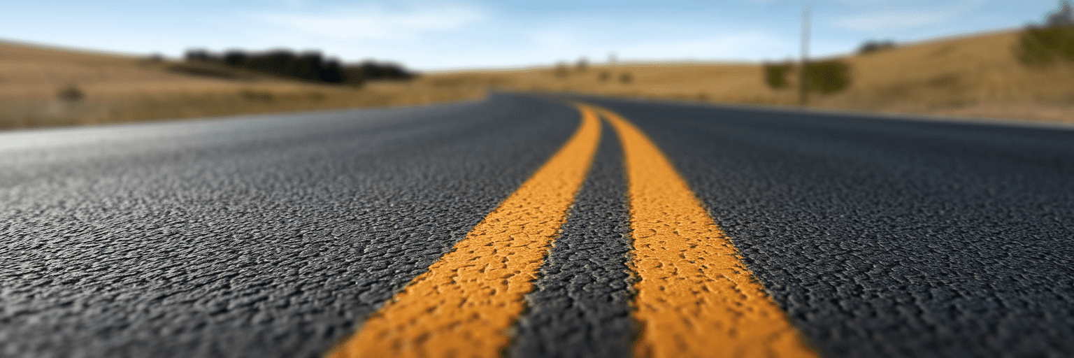 Smooth paved road through countryside.