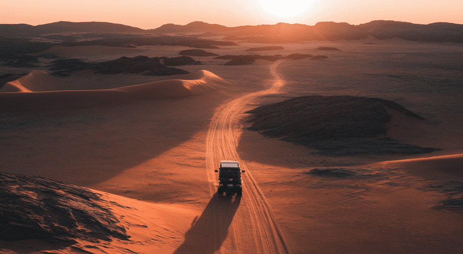 Lone 4x4 vehicle on desert trail at sunset