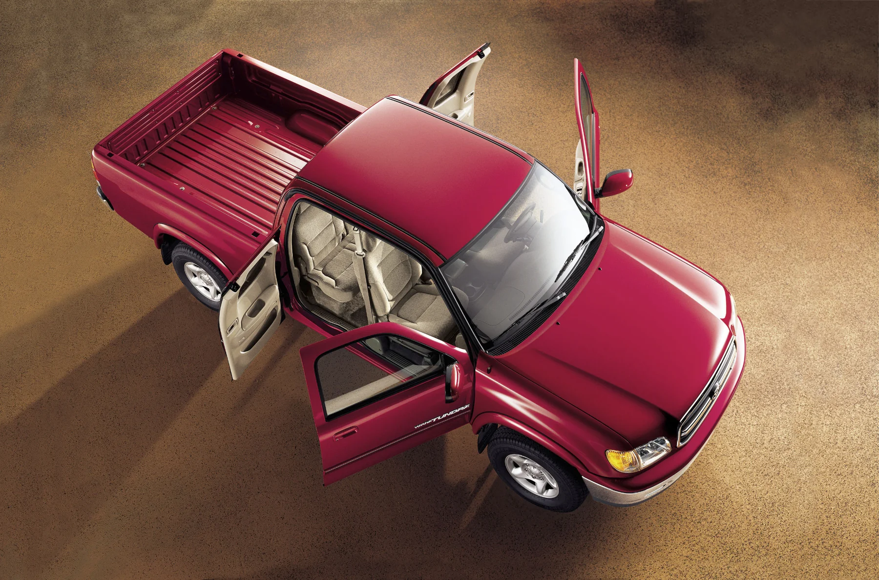 Overhead view of a red 2000 Toyota Tundra Access Cab with its doors open.