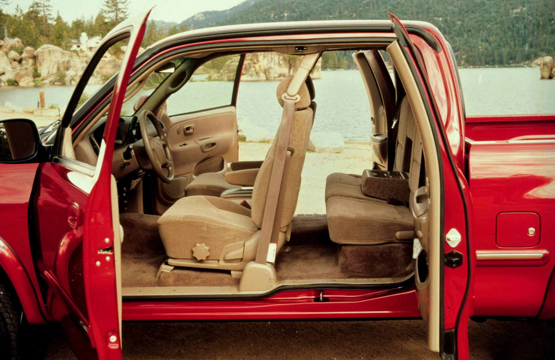 Open front and rear access doors on a red 2000 Toyota Tundra, showing the rear seat.