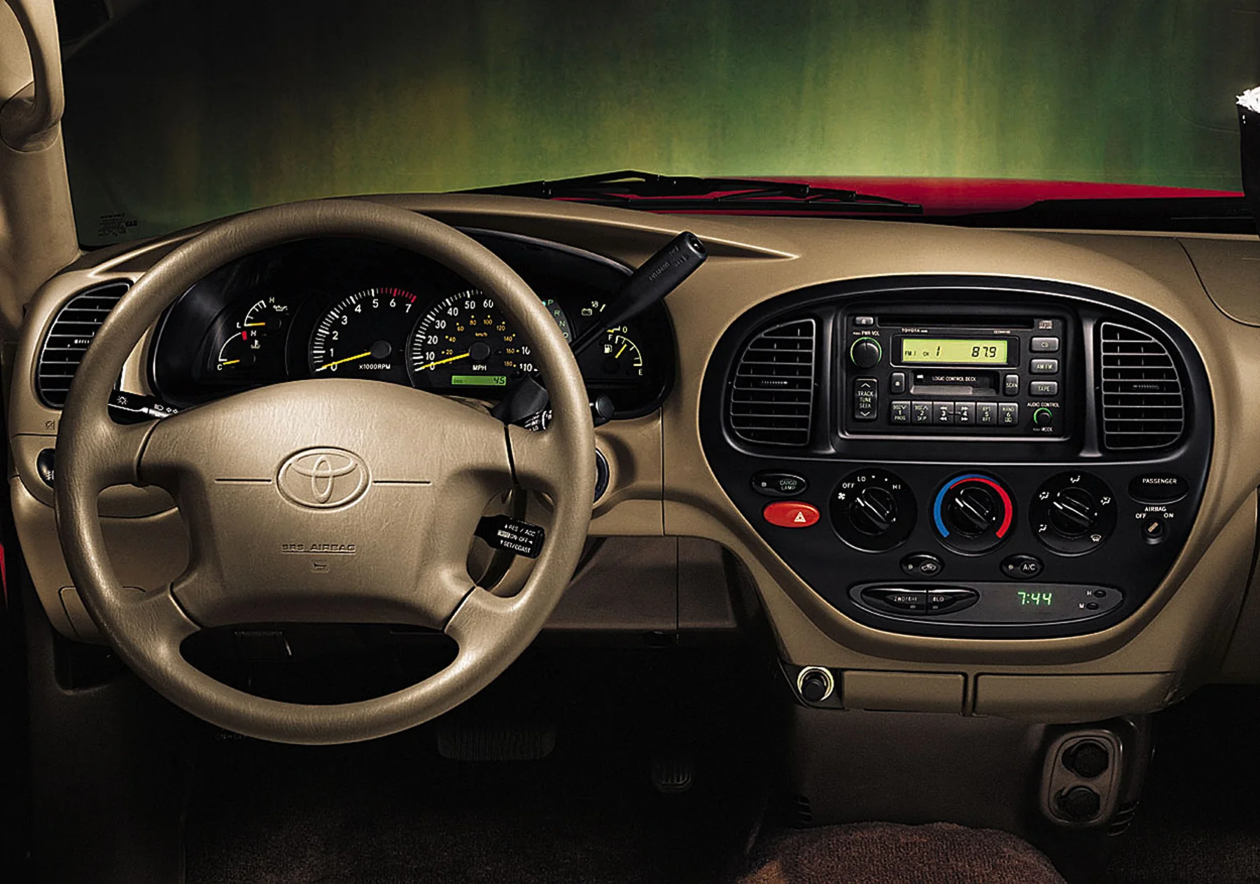 2000 Toyota Tundra dashboard with steering wheel, gauges, radio, and climate controls.