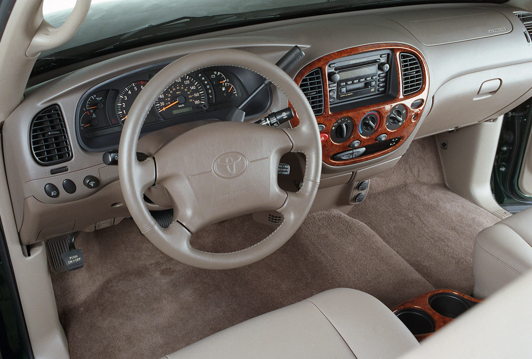2000 Toyota Tundra interior with wood-grain trim around the radio and climate controls.